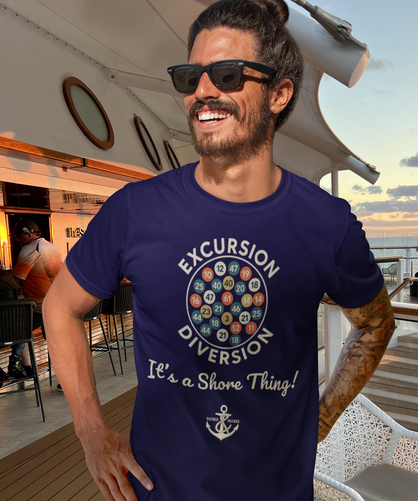 EXCURSION DIVERSION ORIGINAL NAVY CRUISE TEE Man wearing a navy Excursion Diversion cruise T-shirt with It's a Shore Thing slogan onboard a cruise ship